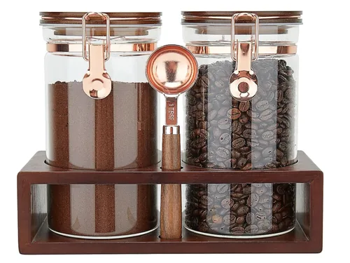 Glass coffee bean canisters on bamboo wood shelf